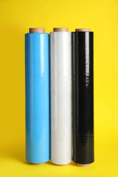 Rolls of different stretch wrap on yellow background