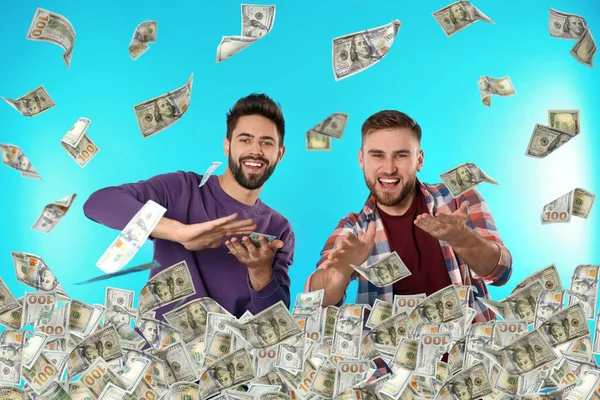 Happy Young Men Money Falling American Dollars Turquoise Background — Stock Photo, Image