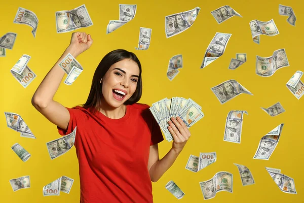 Happy Young Woman Money Falling American Dollars Yellow Background — Stock Photo, Image