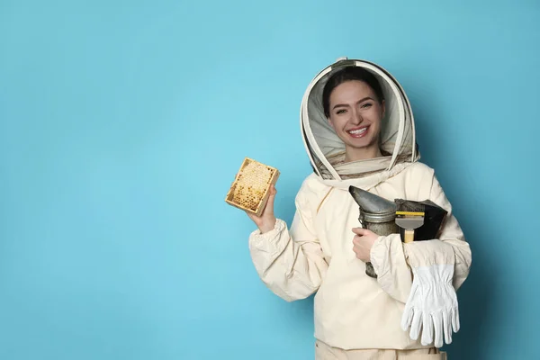 Beekeeper Uniform Holding Smokepot Hive Frame Honeycomb Light Blue Background — стоковое фото