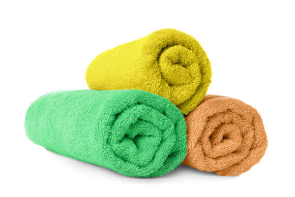 Rolled clean turquoise towels on white background