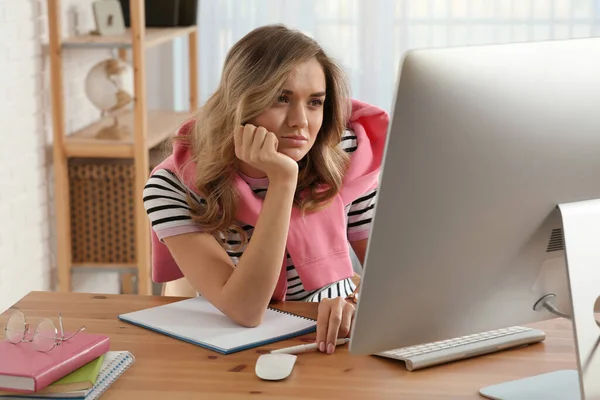 Online test. Woman studying with computer at home