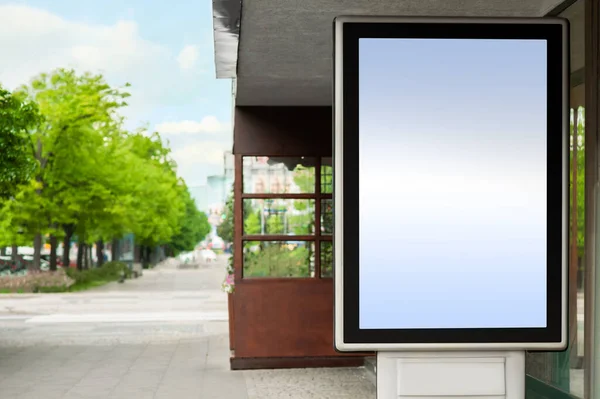 Blank advertising board on city street. Mockup for design