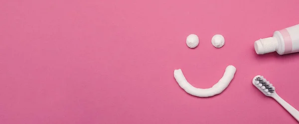 Lächelndes Gesicht Aus Zahnpasta Bürste Und Tube Auf Rosa Hintergrund — Stockfoto