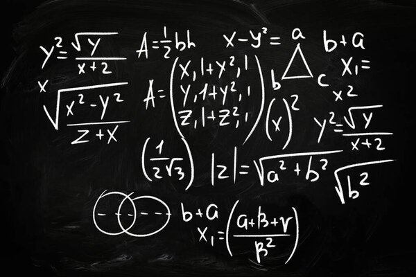 Many different math formulas written on chalkboard