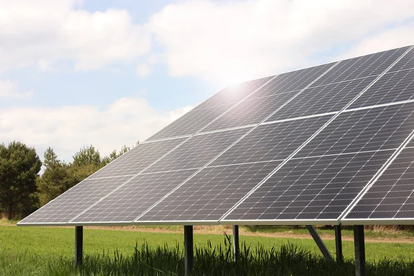 Solar panels in field on sunny day. Alternative energy