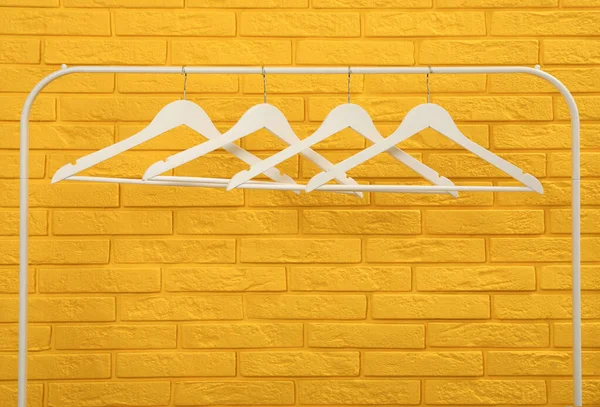 Wardrobe Rack Many Hangers Yellow Brick Wall — Photo