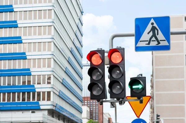 Traffic lights and Pedestrian Crossing road sign in city