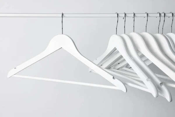 White Clothes Hangers Metal Rail Light Background — Stock Photo, Image