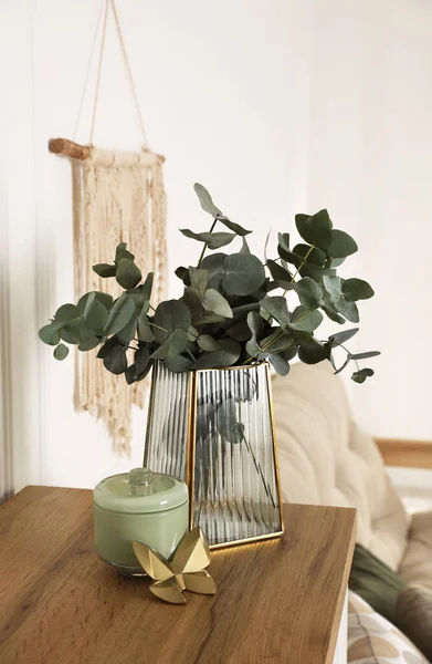 Snygg Glasvas Med Eukalyptusgrenar Och Vackra Inredningsdetaljer Träbord Inomhus — Stockfoto