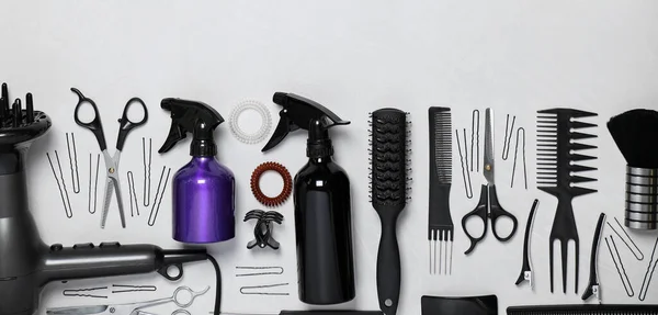 Set of professional hairdresser\'s tools on light background, flat lay. Banner design