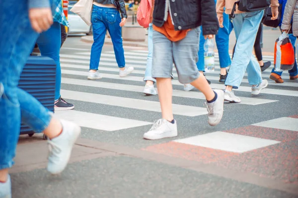 People crossing street in city, closeup view