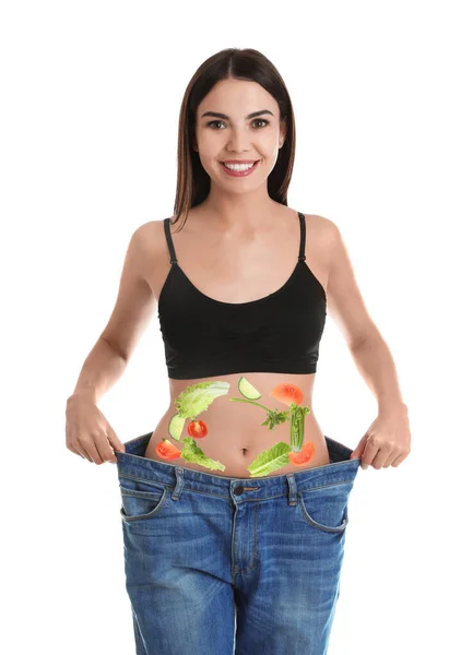 Slim Young Woman Wearing Oversized Jeans Images Vegetables Her Belly — Stock Photo, Image