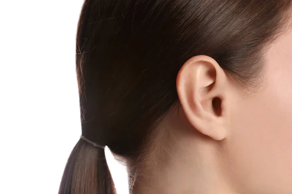 Woman on white background, closeup view of ear