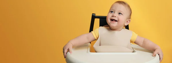 Cute Little Baby Wearing Bib Highchair Yellow Background Space Text — Stock Photo, Image