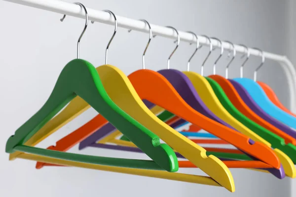 Bright Clothes Hangers Metal Rack Light Background Closeup — Stock Photo, Image