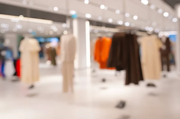 Blurred view of modern boutique interior with stylish clothes