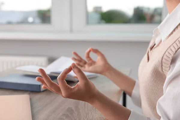 Find zen. Woman taking break from work at table in room, closeup