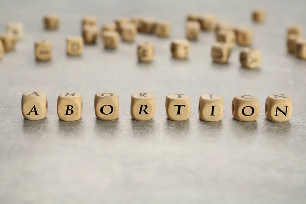 Λέξη Έκτρωση Από Ξύλινους Κύβους Γκρι Τραπέζι Closeup — Φωτογραφία Αρχείου