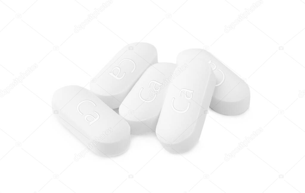 Pile of calcium supplement pills on white background