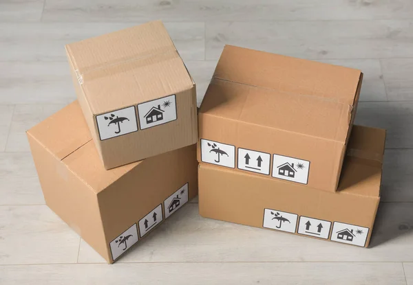 Many Closed Cardboard Boxes Packaging Symbols Wooden Floor Delivery Service — Stockfoto