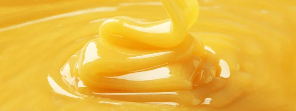 Closeup view of tasty honey as background. Banner design