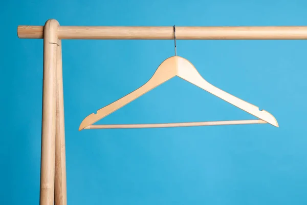 Empty Clothes Hanger Wooden Rack Light Blue Background — 스톡 사진