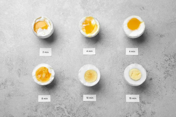 Different Cooking Time Readiness Stages Boiled Chicken Eggs Light Grey — Stockfoto