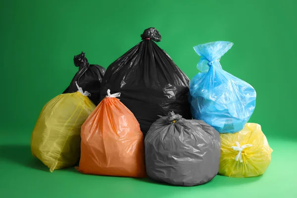 Trash Bags Full Garbage Green Background — Stock fotografie