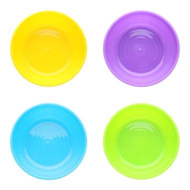 Set with colorful plastic plates on white background, top view. Serving baby food