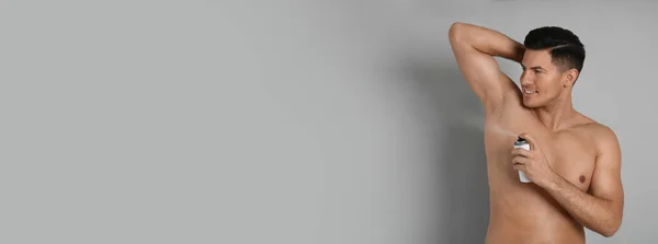 Handsome Man Applying Deodorant Armpit Grey Background Space Text Banner — Stok fotoğraf