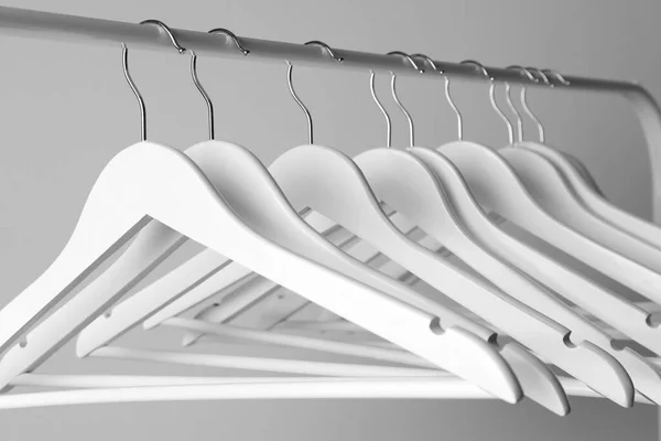 White Clothes Hangers Metal Rail Light Background Closeup — Stock Photo, Image