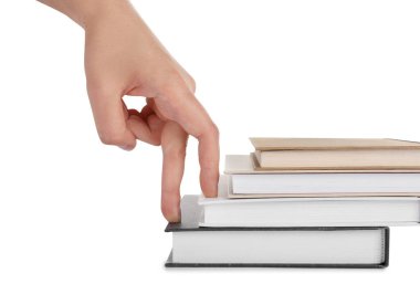 Woman imitating stepping up on books with her fingers against white background, closeup