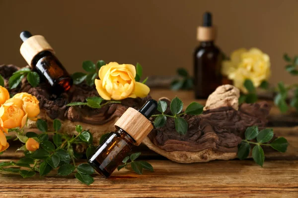 Bottles Rose Essential Oil Flowers Wooden Table — Stock Photo, Image