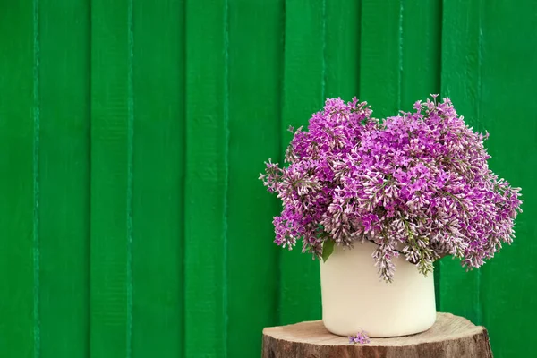 Beautiful Lilac Flowers Vase Wooden Stump Green Background Space Text — ストック写真