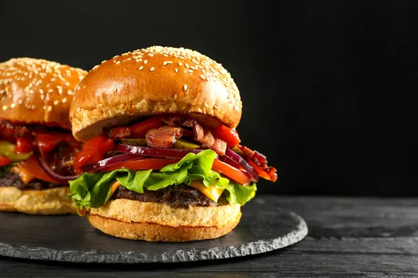Tasty Burgers Black Wooden Table Closeup Space Text Fast Food — Zdjęcie stockowe
