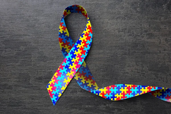 World Autism Awareness Day Colorful Puzzle Ribbon Grey Stone Background — ストック写真