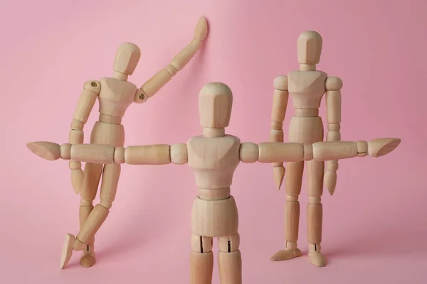Wooden Human Models Different Poses Pink Background — Stock Photo, Image