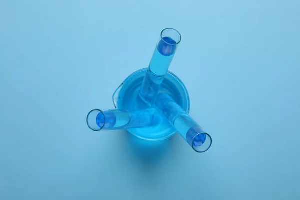 Laboratory Glassware Light Blue Liquid Turquoise Background Top View — ストック写真