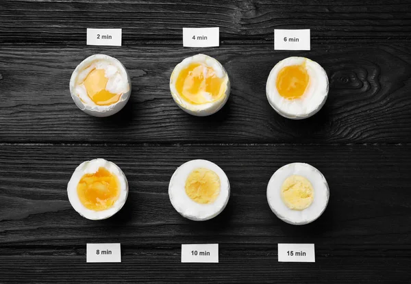 Different Cooking Time Readiness Stages Boiled Chicken Eggs Black Wooden — Stockfoto