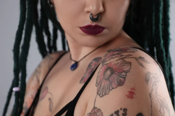 Young Woman Tattoos Body Nose Piercing Dreadlocks Grey Background Closeup — Stockfoto