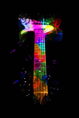 Bright colorful design with electric guitar on black background, closeup. Rock music concept