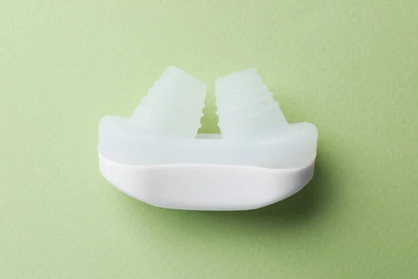 Snoring Device Nose Light Green Background Top View — Stock fotografie