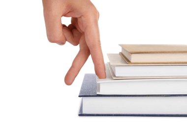 Woman imitating stepping up on books with her fingers against white background, closeup