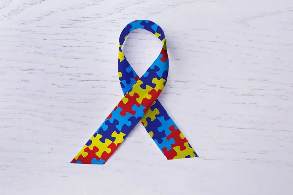 World Autism Awareness Day Colorful Puzzle Ribbon White Wooden Background — ストック写真