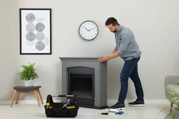 Man Installing Electric Fireplace Wall Room — Stockfoto