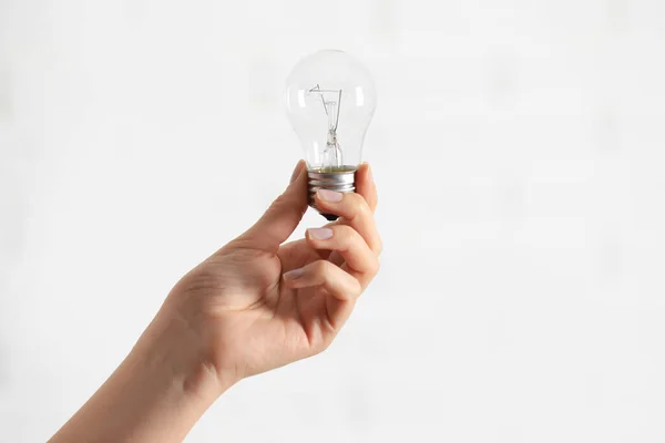 Woman Holding Light Bulb White Background Closeup Space Text — Foto de Stock