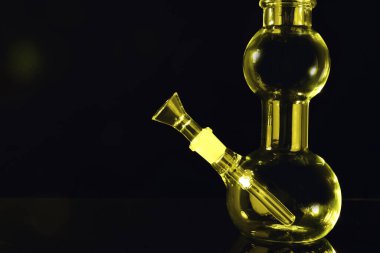 Siyah arkaplanda cam nargilenin yakın görüntüsü, metin için boşluk. Sigara içme aygıtı