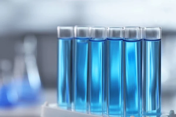 Test Tubes Light Blue Liquid Blurred Background Closeup — Stock Photo, Image