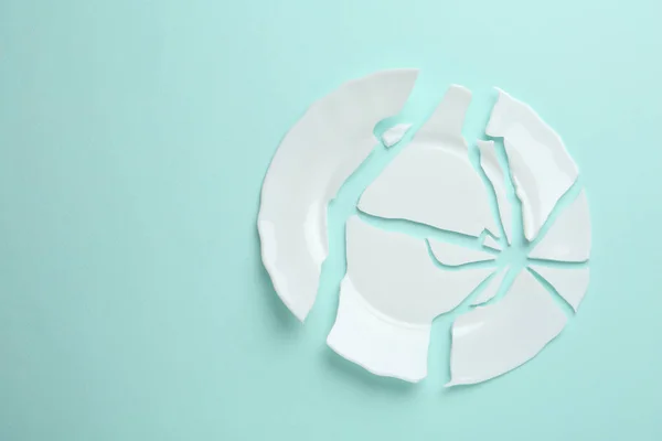 Pieces Broken Ceramic Plate Light Blue Background Flat Lay Space — Zdjęcie stockowe